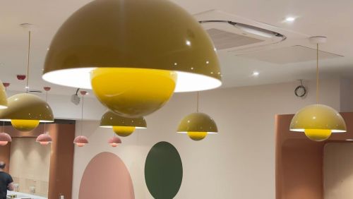 yellow lightbulb in colourful room with polkadot wallpaper
